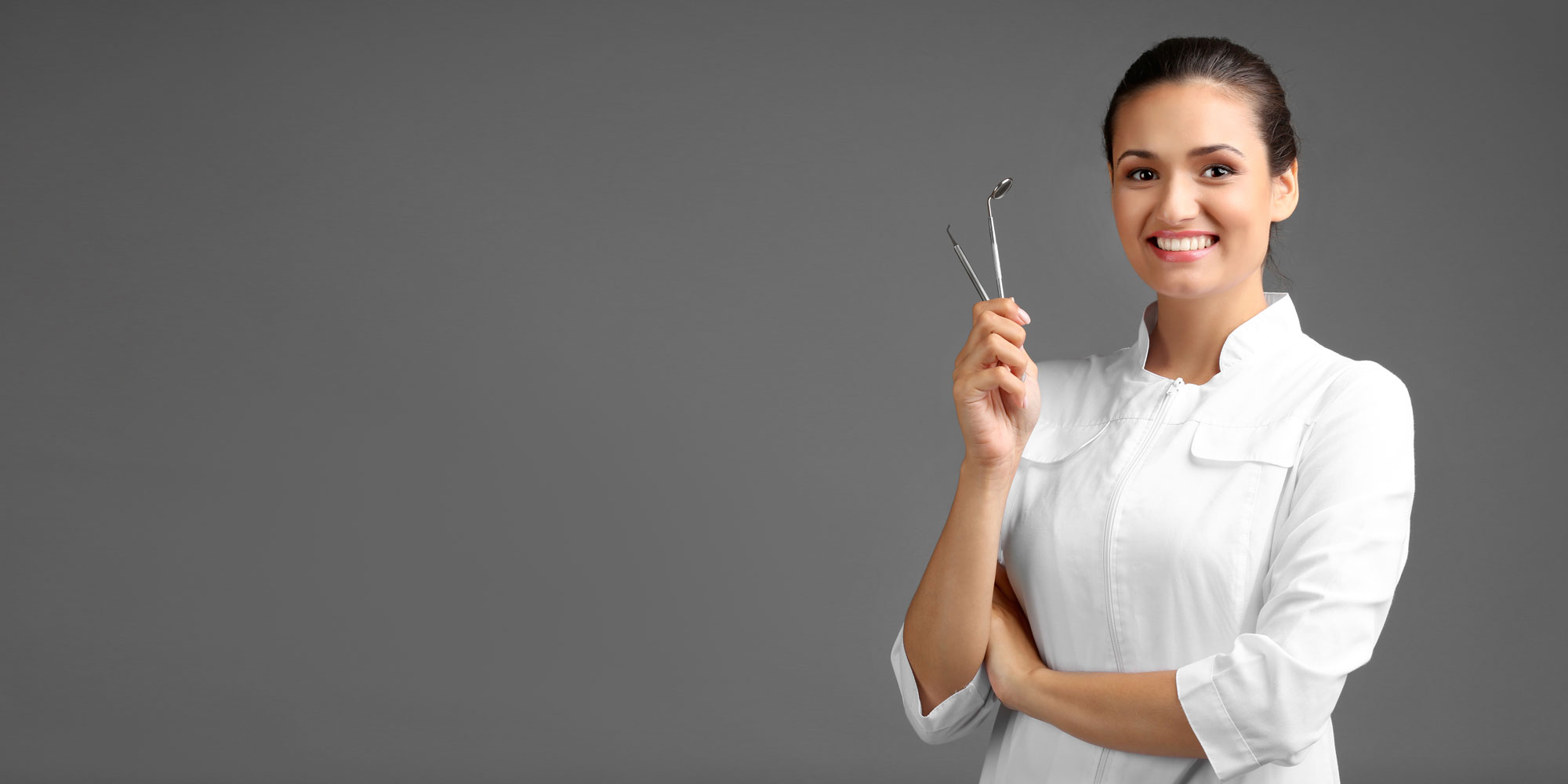dentist smiling with dental tools