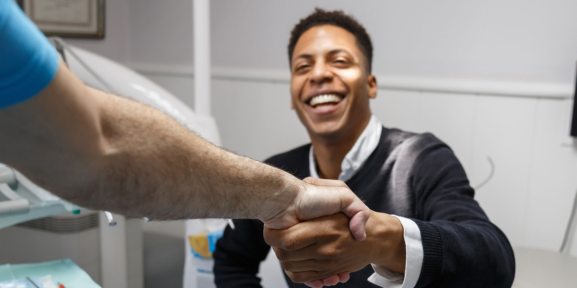 patient shaking hands with dentist at the dental center