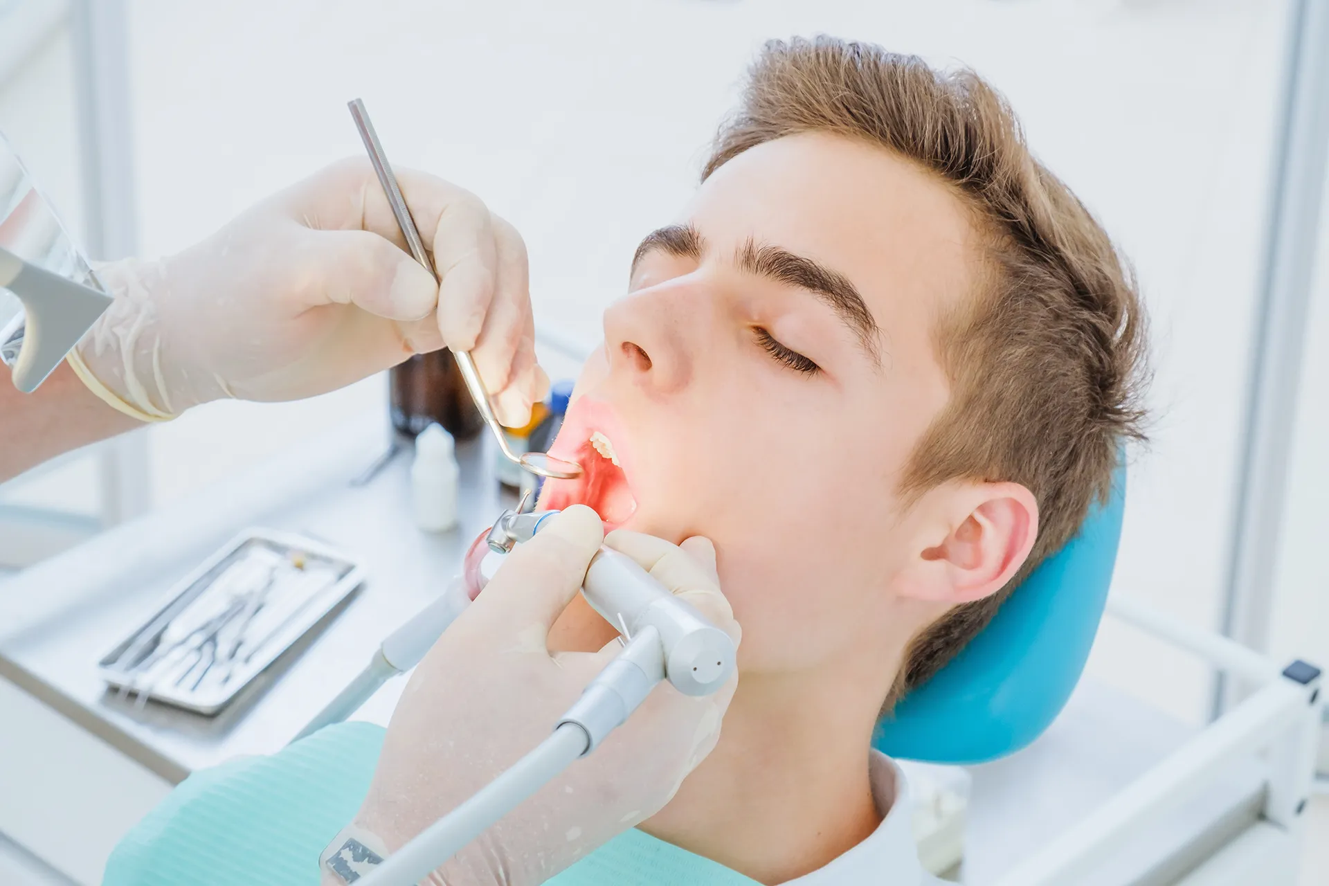 Male patient at the dentist's chair during a dental procedure.