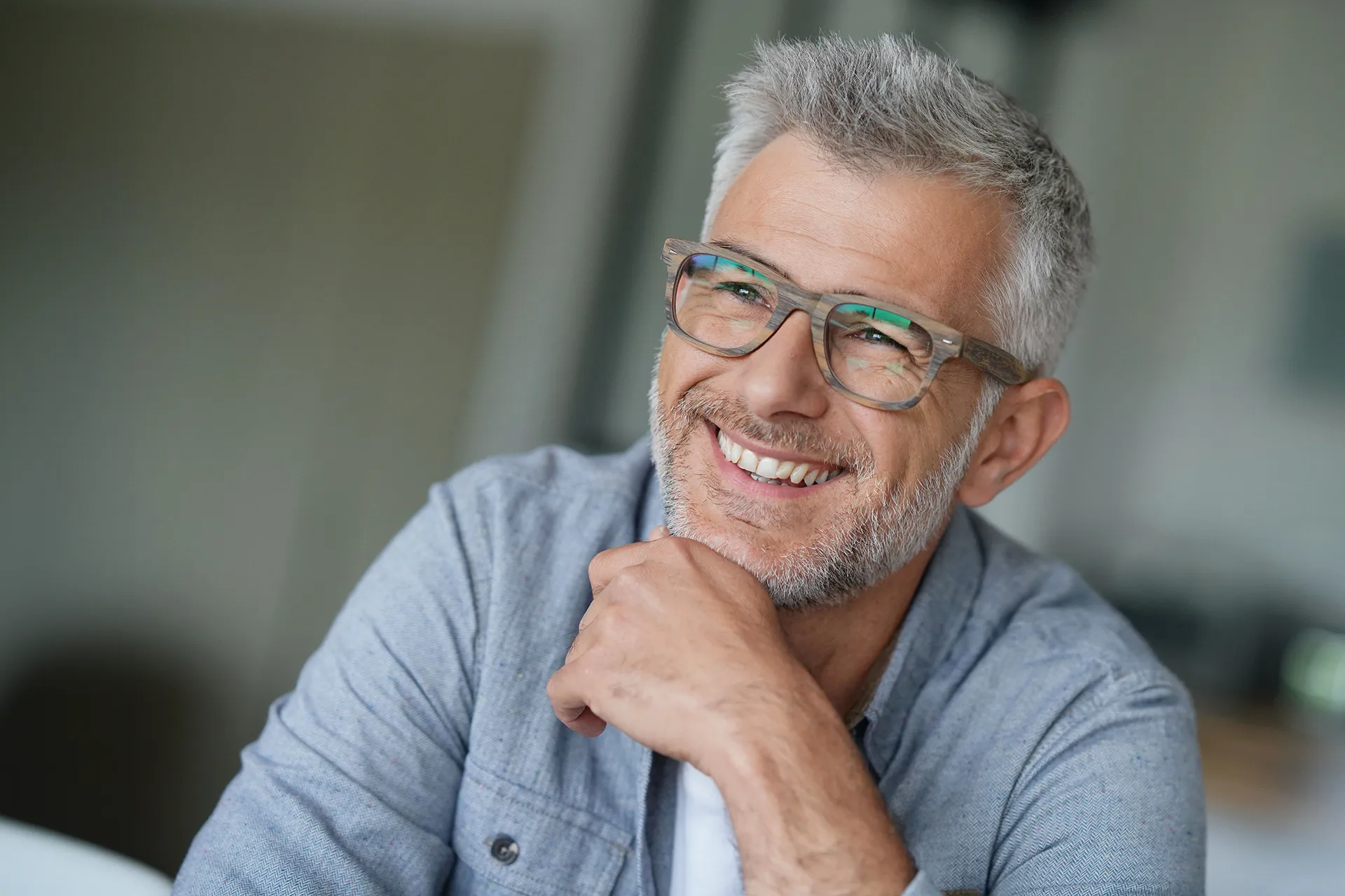 Close up of a man with glasses smiling.
