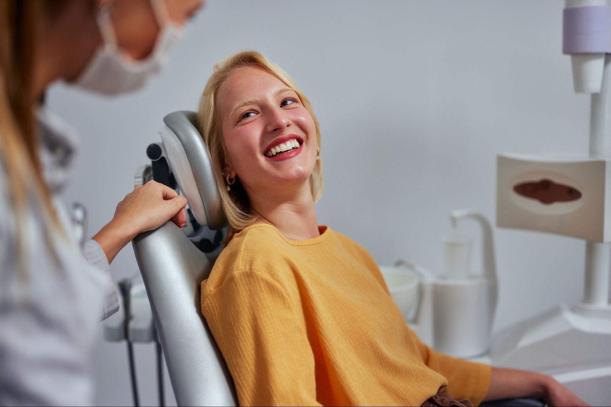 Girl smiling in a dental exam chair. 