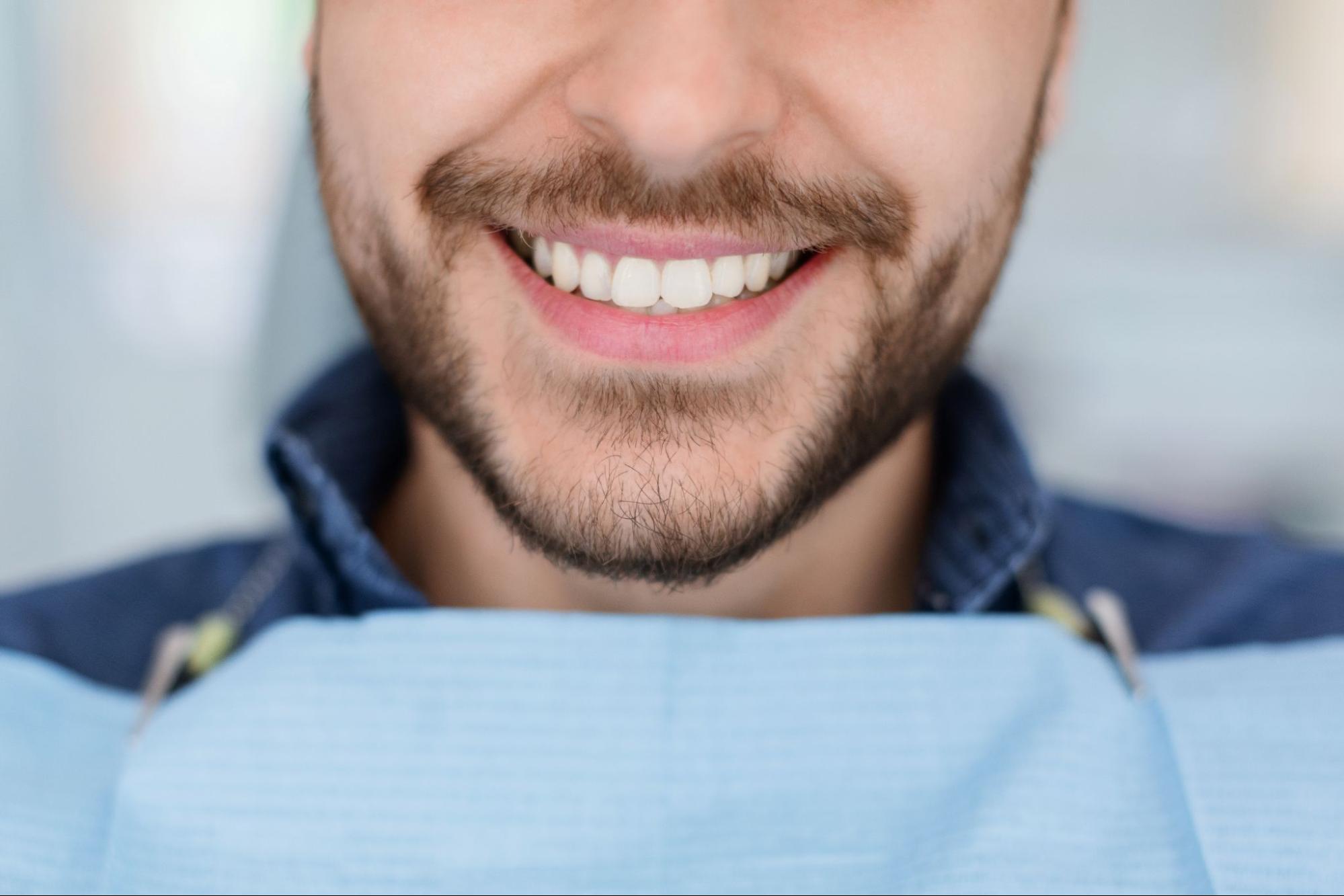 Man smiling in an exam chair. 