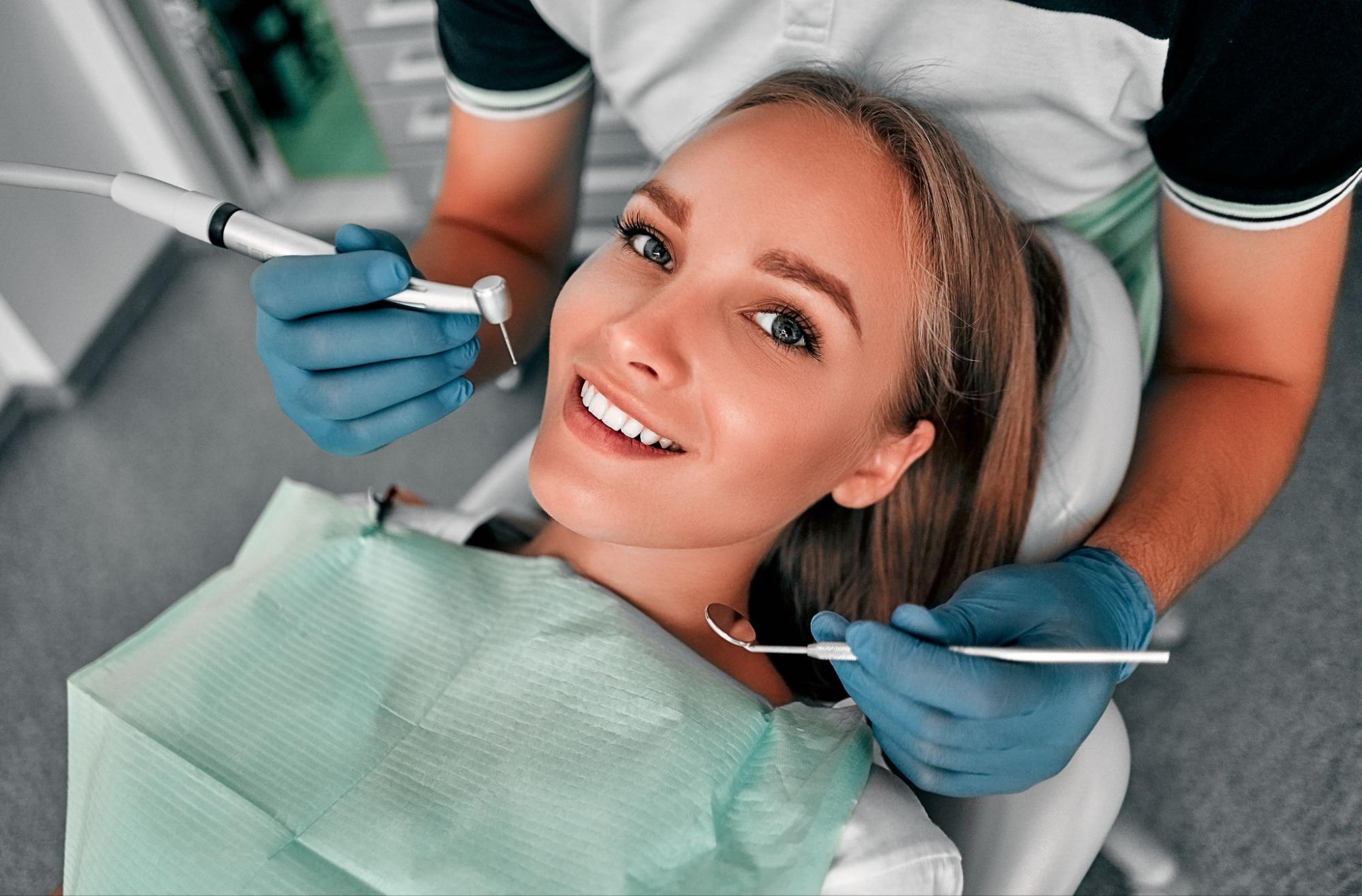 Woman in a dental exam chair smiling.