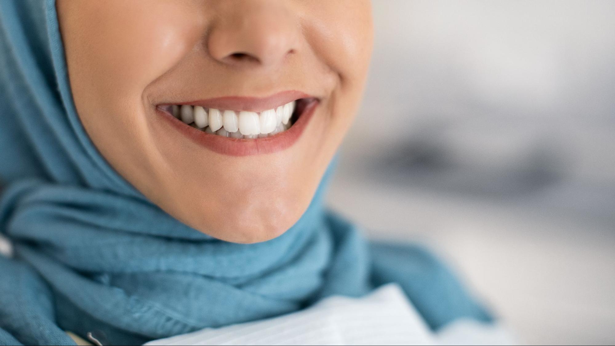 Woman with white teeth smiling. 