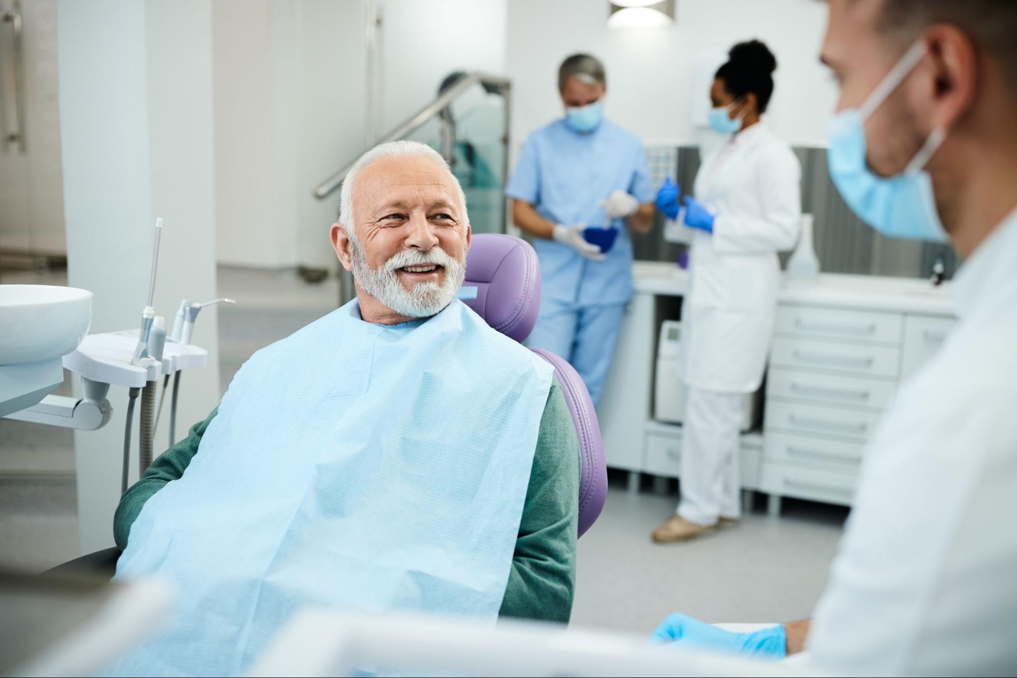 Elderly man smiling at the dentist. 
