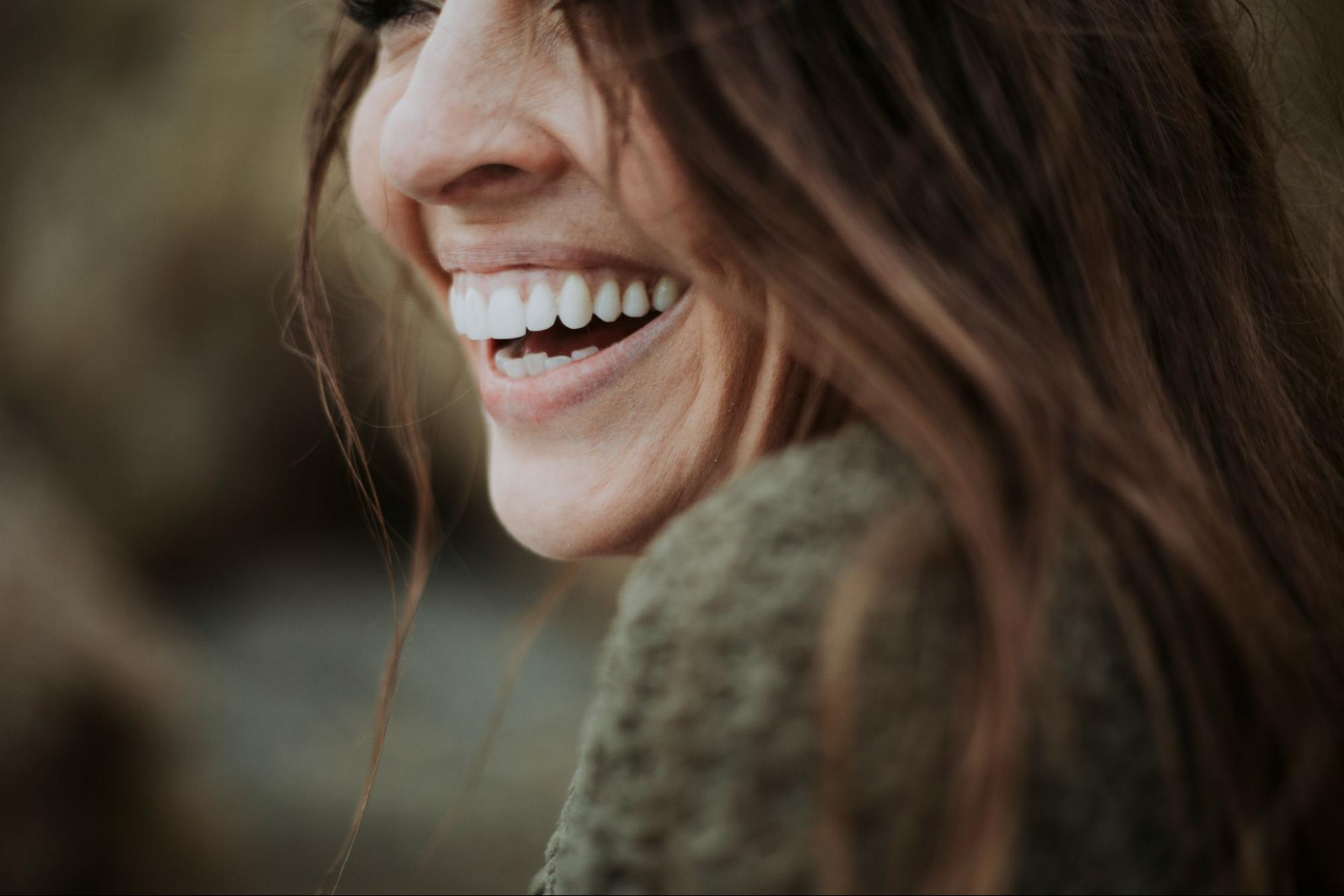 Woman with a straight, white smile from the nose down. 