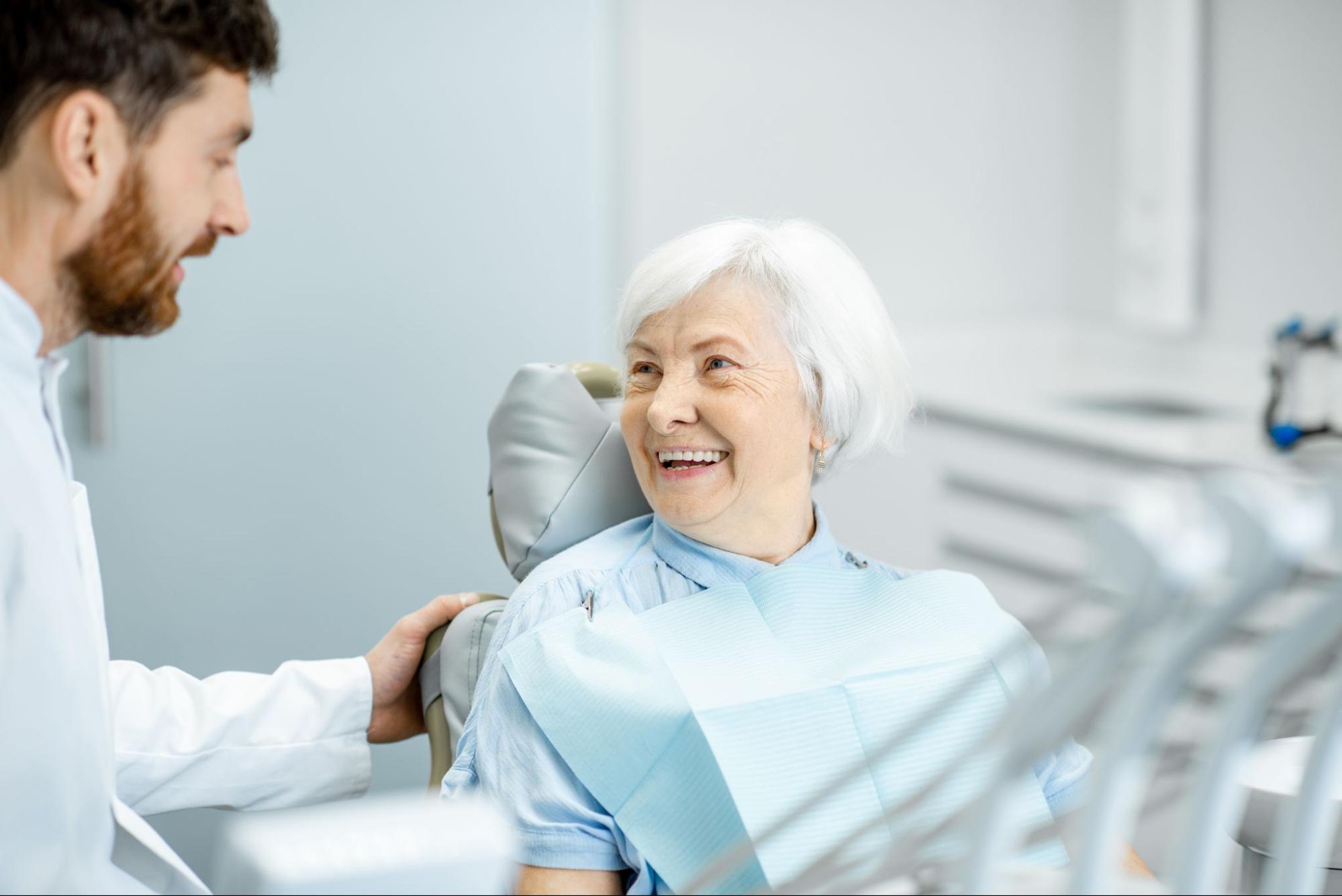 Elderly woman smiling at the dentist.