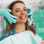 Dentist explaining oral health to a patient in a clean dental office.