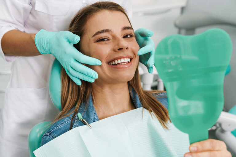 Dentist explaining oral health to a patient in a clean dental office.