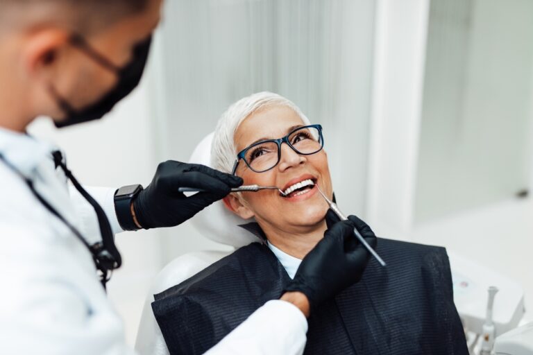 Dentist discussing teeth cleaning with a patient in a modern office