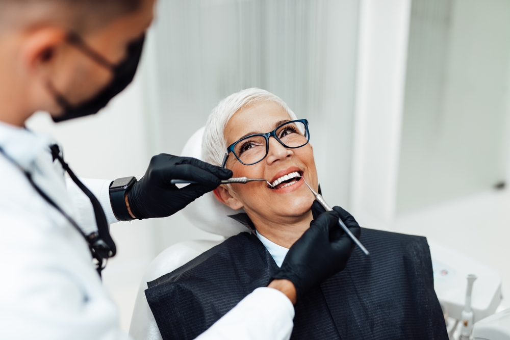 Dentist discussing teeth cleaning with a patient in a modern office