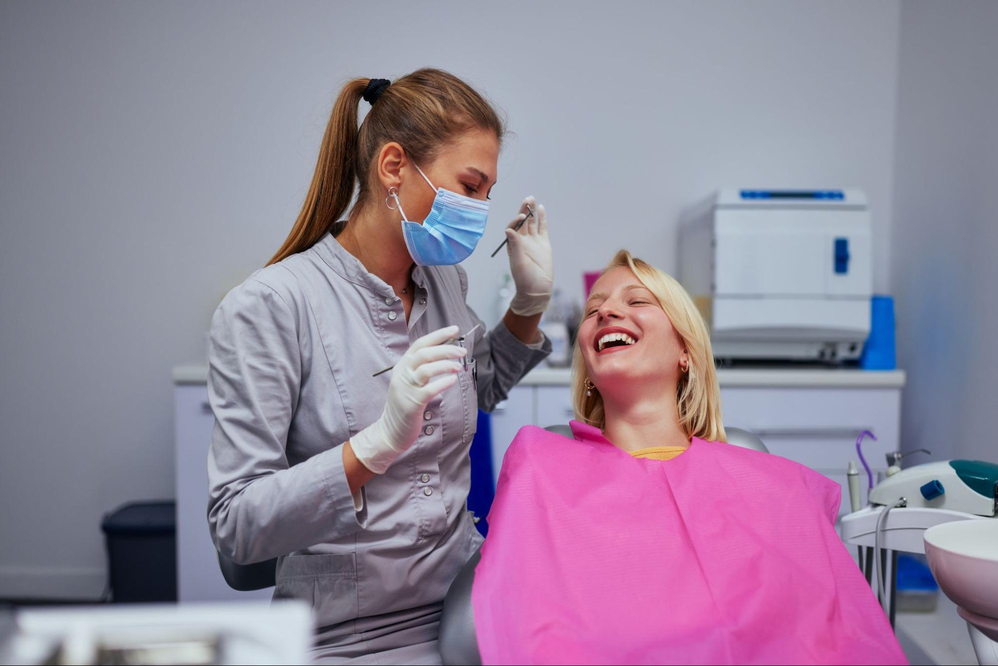Regular teeth cleaning at a dental office, showing the dentist and patient engaging in a friendly discussion before the procedure begins.