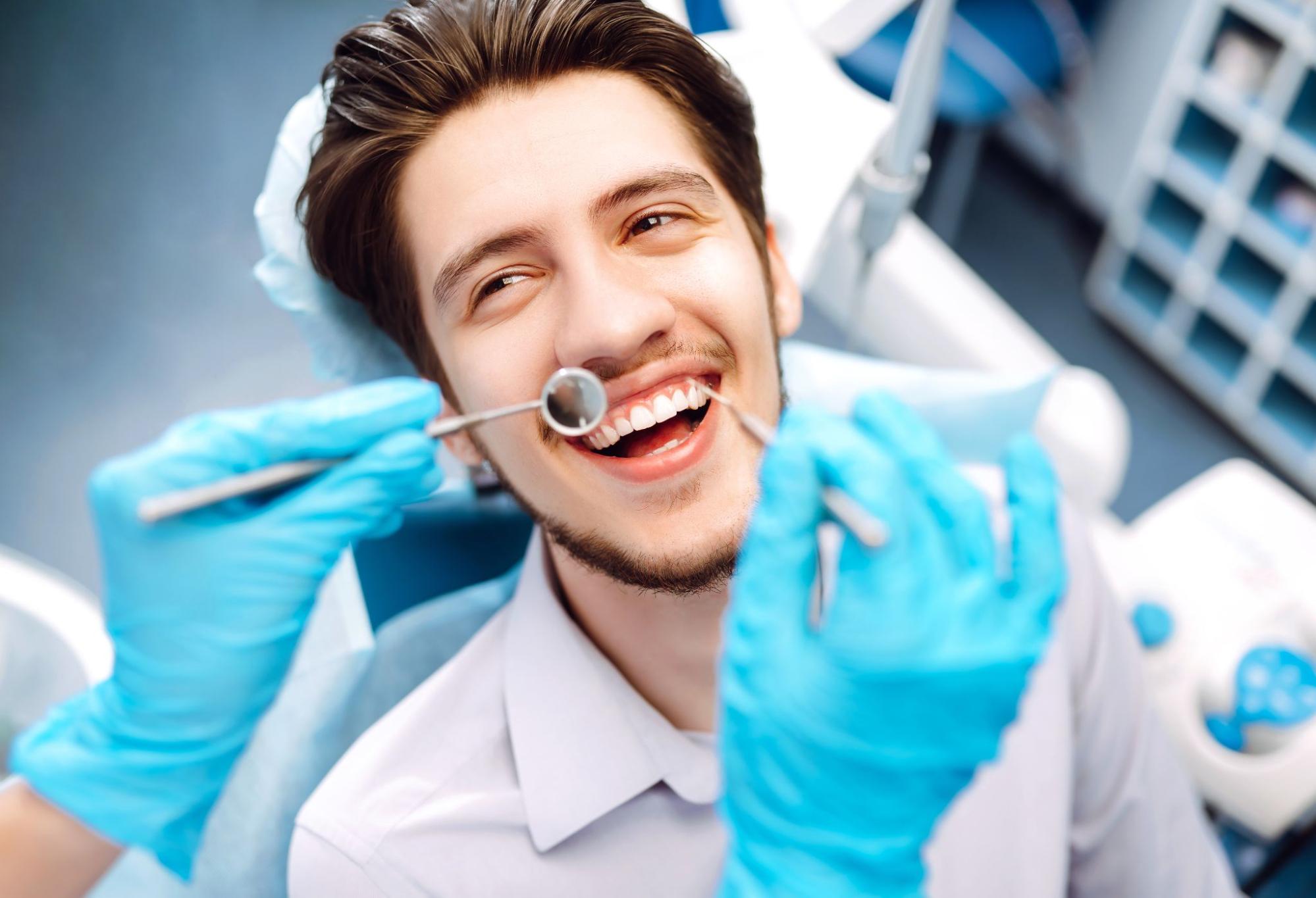 Happy man in a dental exam chair. 