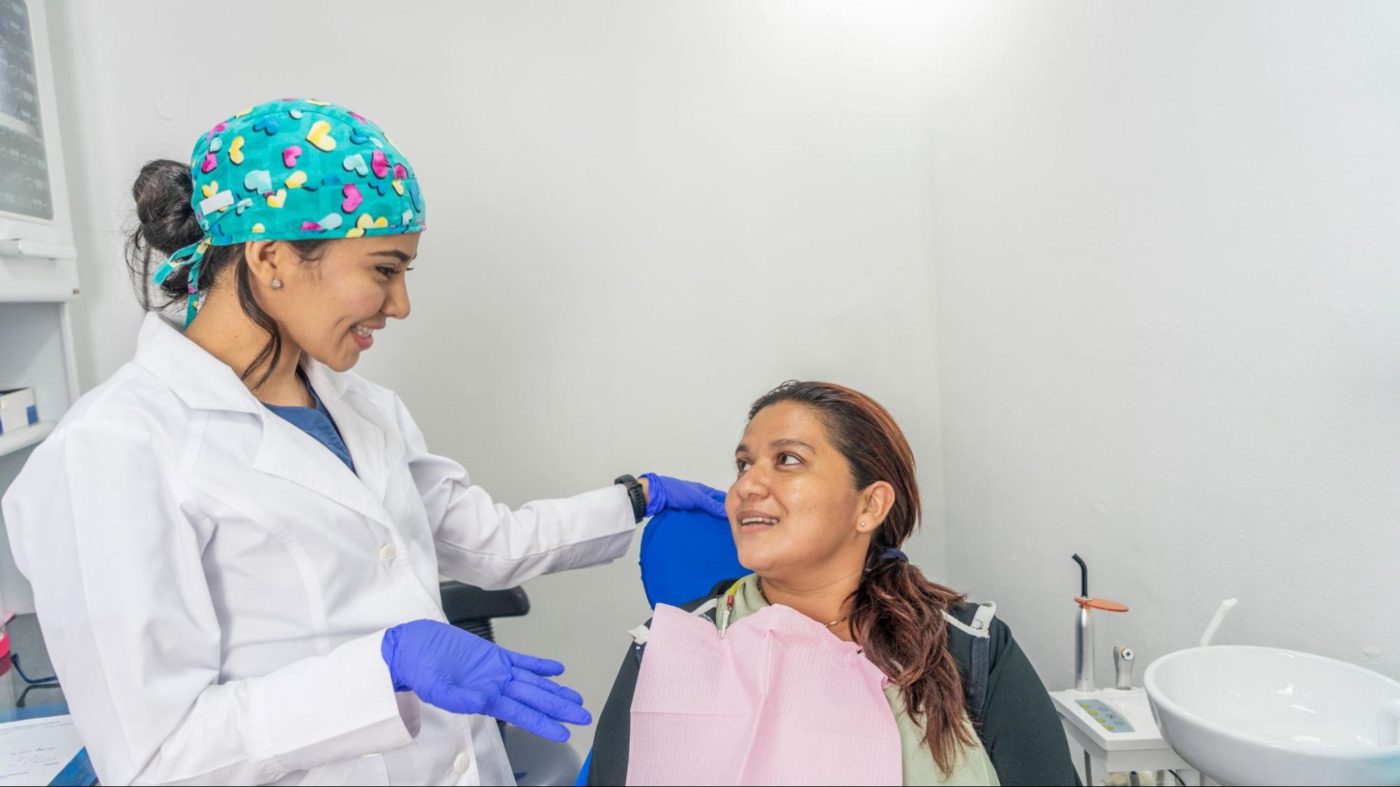 Girl speaking to a female dentist. 