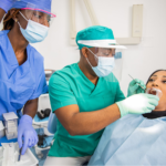 A dentist and a nurse working on a patient.