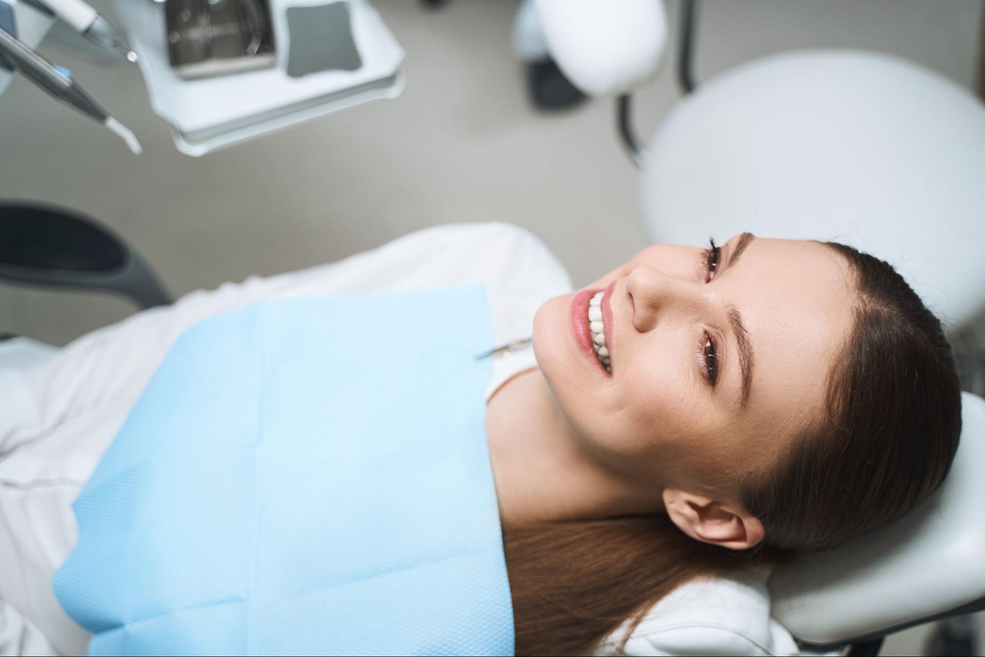 Woman smiling in an exam chair. 