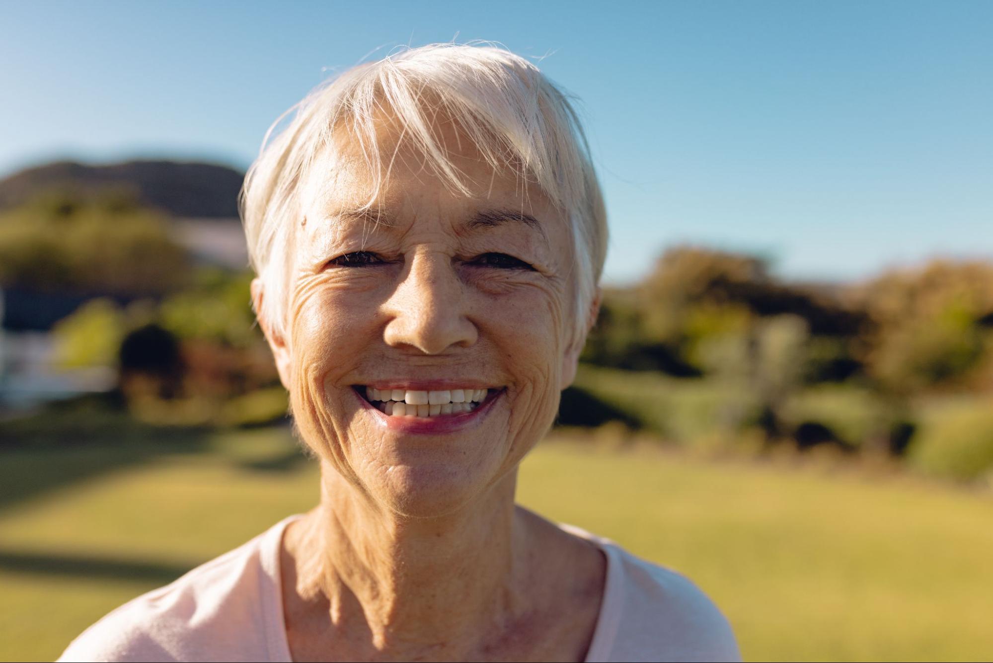 Elderly woman with dentures smiling. 