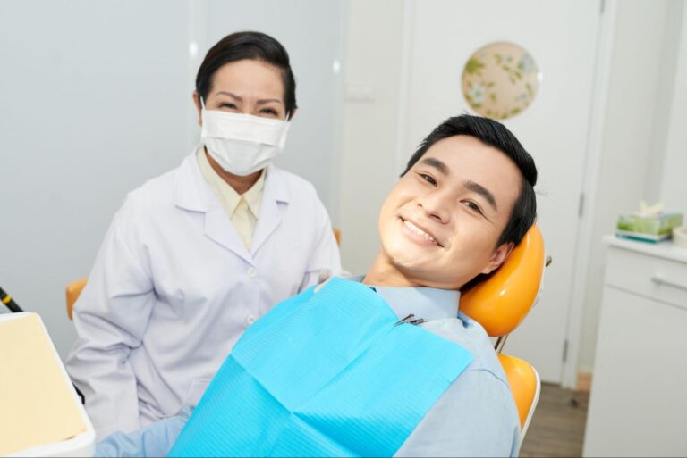 Patient next to a female dentist wearing a mask.