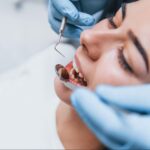 Overhead view of a young woman during a dental checkup at a clinic.