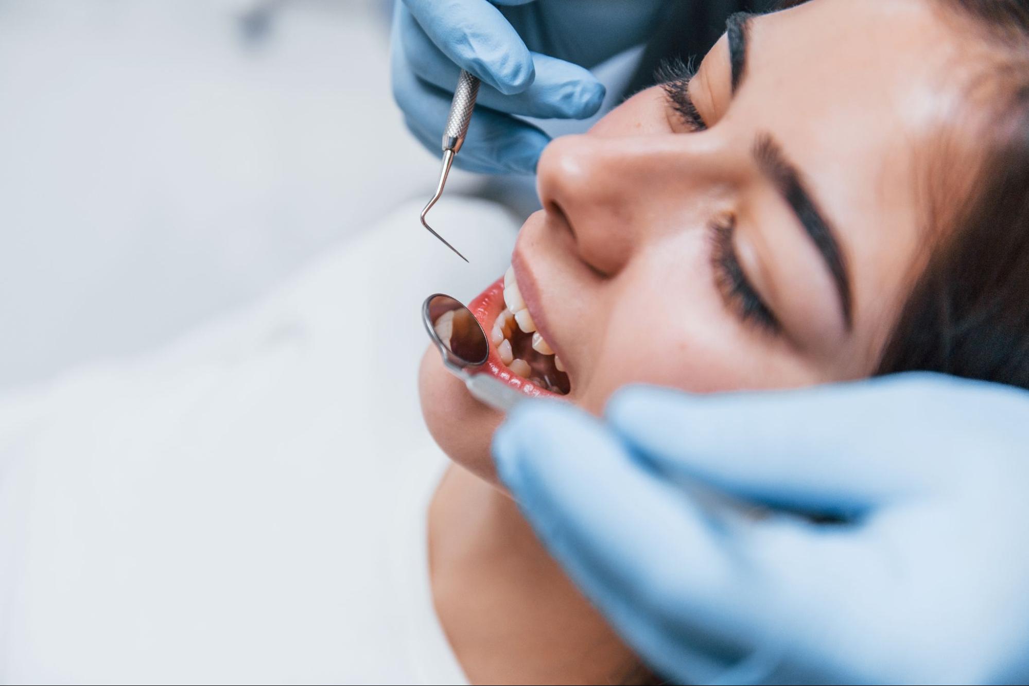 Overhead view of a young woman during a dental checkup at a clinic.