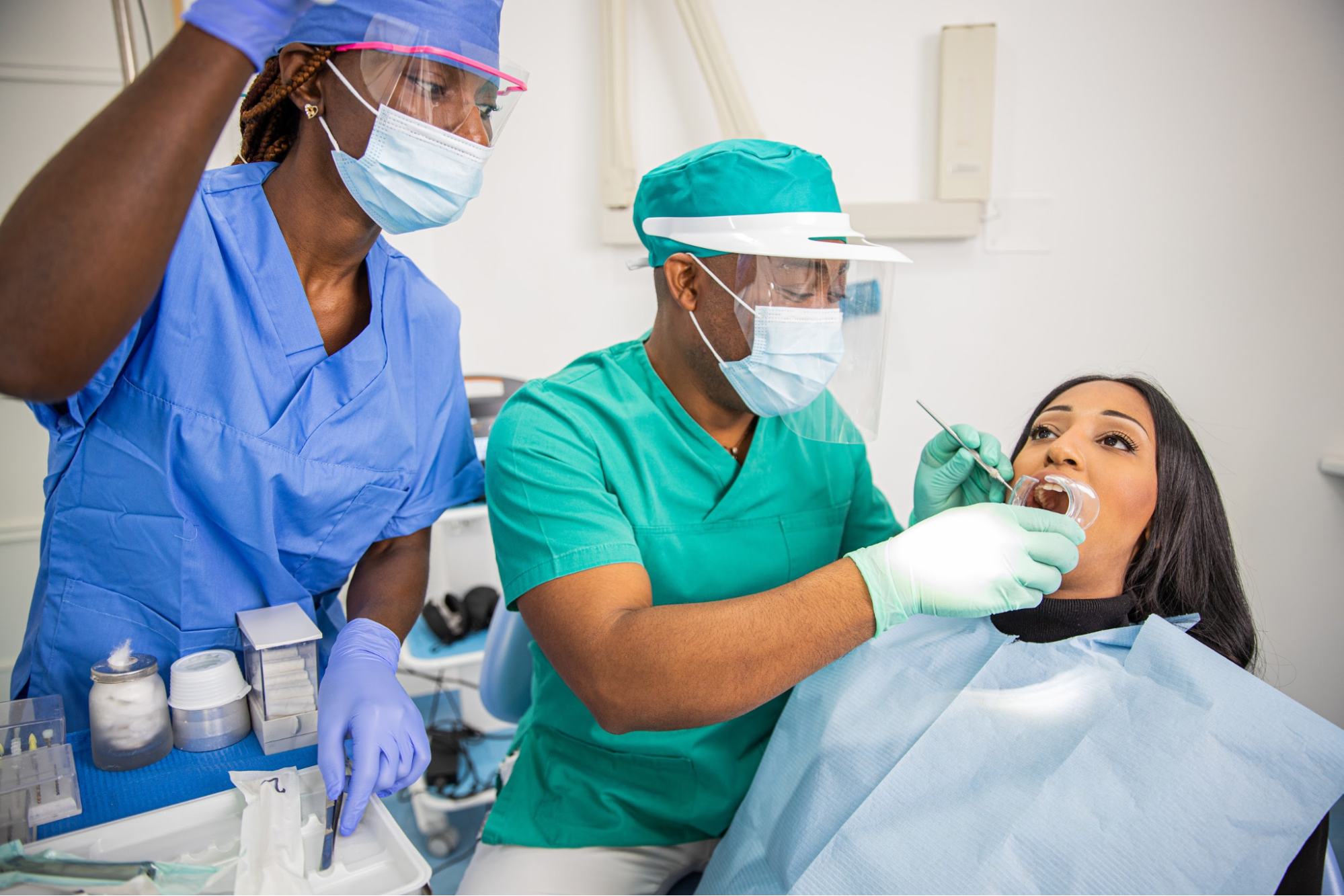 A dentist and a nurse working on a patient.