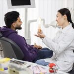 Male patient next to a female dentist.