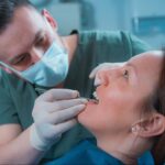 A patient undergoing a dental examination by a dentist.
